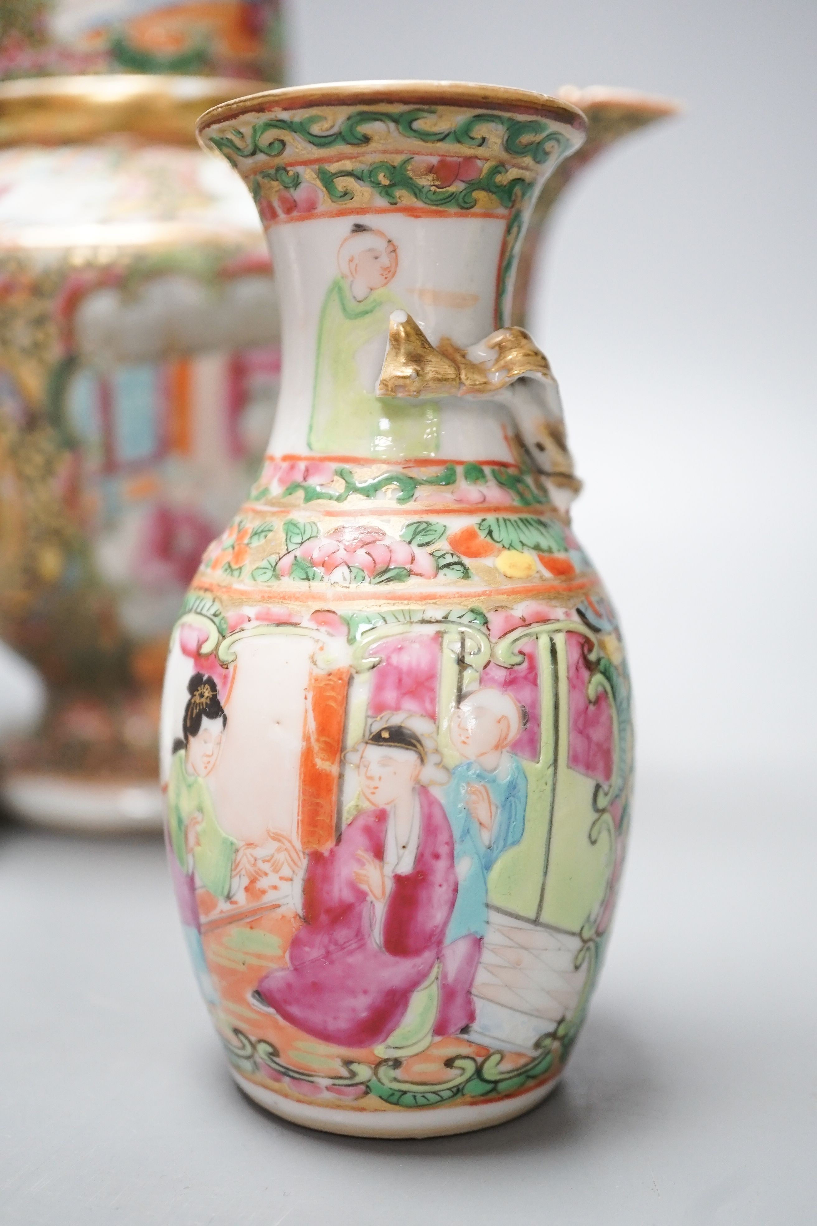 A 19th century Chinese famille rose teapot, sugar bowl, saucer dish vase and a similar yellow ground ‘dragon’ vase and cover 21cm